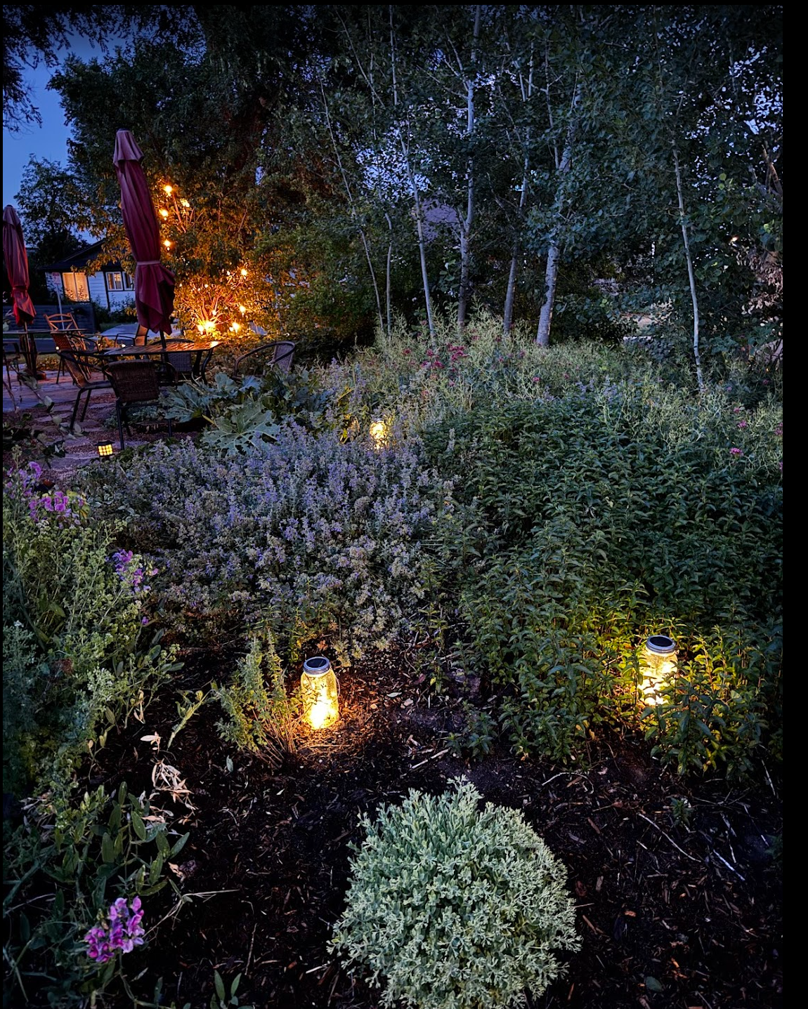 Garden with mason-jar lanterns at dusk