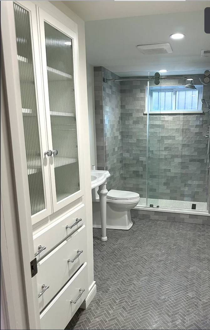 Frameless glass shower with built-in cabinet